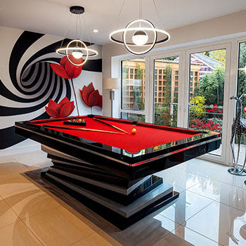 modern red felt snooker table in luxury indoor game room with spiral wall art and garden view.