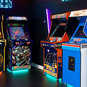 retro arcade room with neon signs and six classic machines including RoboCop, Space Invaders, and Mortal Kombat under industrial ceiling pipes.