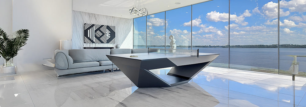 Sculptural modern table tennis table in luxury high-rise apartment with floor-to-ceiling ocean view windows and marble floors.