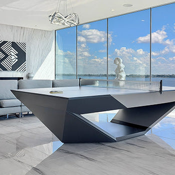 Sculptural modern table tennis table in luxury high-rise apartment with floor-to-ceiling ocean view windows and marble floors.