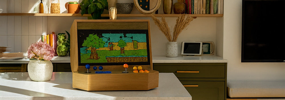 wooden arcade machine with blue and orange controls on a kitchen island in a warm, sunlit modern home interior.