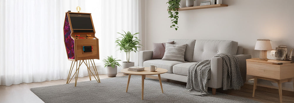 Stylish wooden arcade cabinet with vivid neon side panels and classic joystick controls, featuring a built-in Nintendo Switch, placed in a bright and modern minimalist living room with Scandinavian décor.