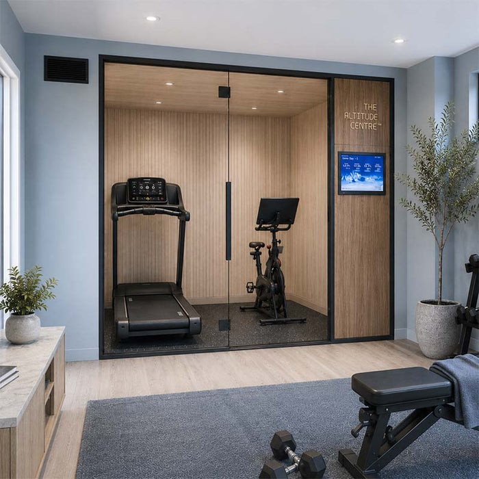 Altitude Centre MetraFit 3000 Active glass-enclosed training pod with light wood interior, housing a treadmill and exercise bike, in a bright home gym with blue-grey walls and natural light.