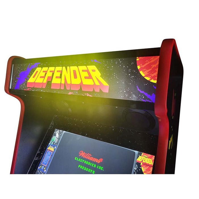 Close-up of Defender title on Arcade WOW machine marquee.