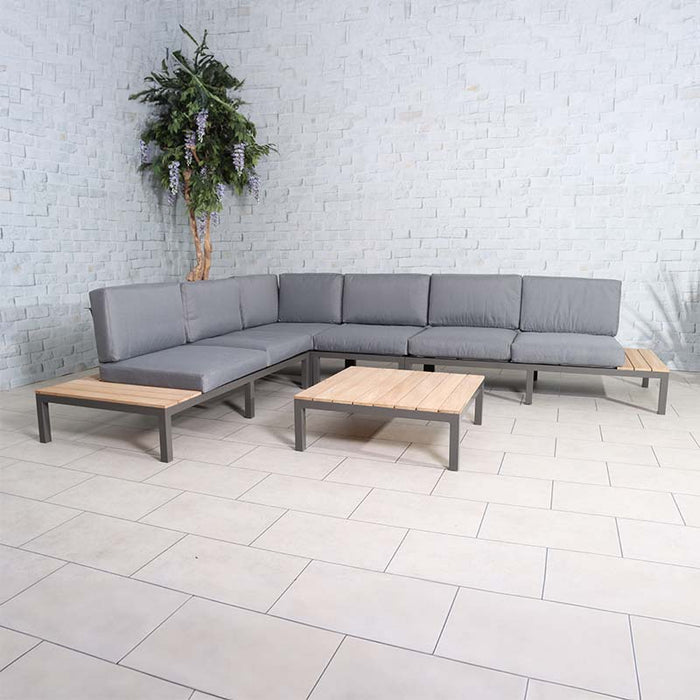 Teak Wood Aspen 6 Seater Corner Lounge Set with grey upholstery, providing ample seating space in a modern indoor environment.