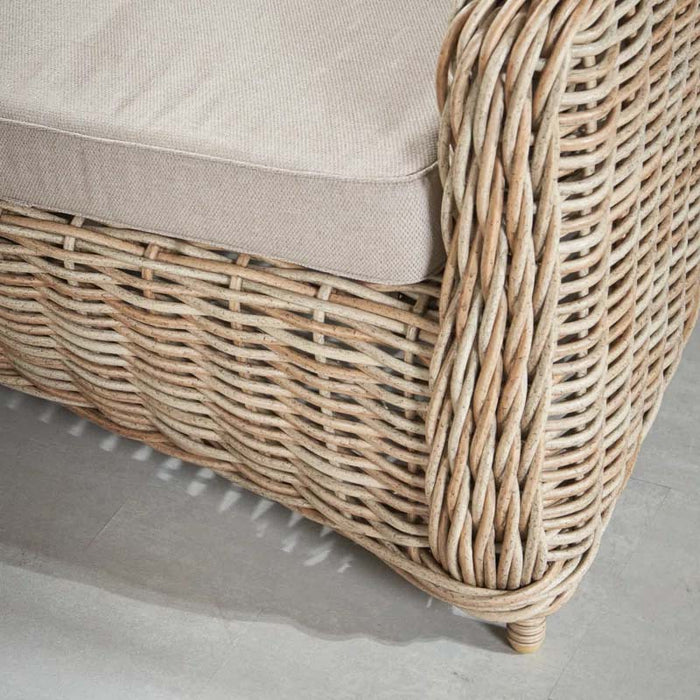 Close-up of the rattan base of the Barakaldo Natural Antique Outdoor Sofa, featuring a durable weave and elegant natural finish.