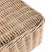 Detailed view of the rattan weave and glass top on the corner of the Barakaldo Natural Antique Outdoor Coffee Table.