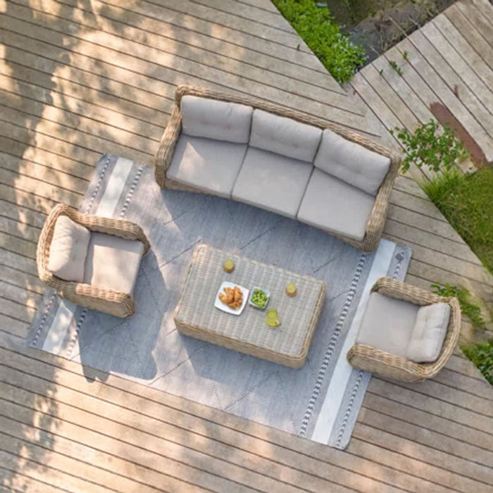 Bird's-eye view of the Barakaldo Natural Antique Outdoor Seating Set arranged on a lakeside deck, featuring a rattan sofa, armchairs, and a coffee table.