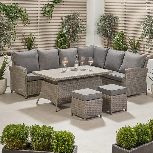 Slate Grey Barbados Corner Set Long Left with Ceramic Top arranged in an outdoor space, showcasing its comfort and style with a corner sofa, adjustable table, and two footstools.