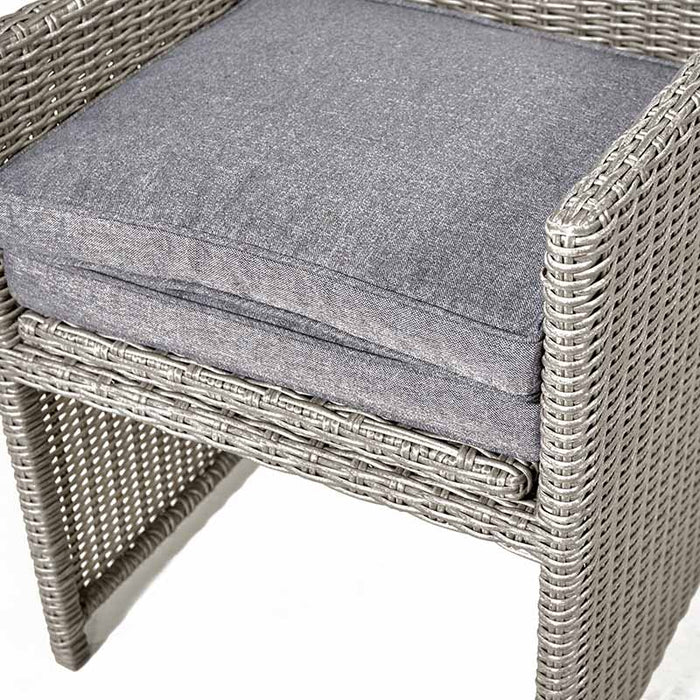 Close-up of a chair from the Stone Grey Bermuda Cube Set with Ceramic Top, showcasing the cushion and wicker detail.