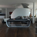 Stylish grey Billards Toulet Blacklight pool table in a contemporary open-plan living room with dark wooden flooring.