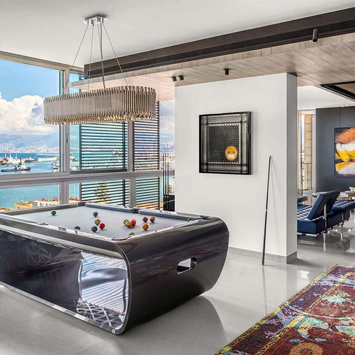 Polished grey Billards Toulet Blacklight pool table with white felt in a stylish high-rise apartment offering sea views and contemporary décor.
