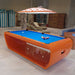 Vibrant orange Billards Toulet Blacklight pool table with bright blue felt in a playful recreational space with beach-inspired decor.