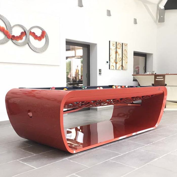 Glossy red Billards Toulet Blacklight pool table in a stylish entertainment room with artistic and bar accents.