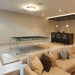 Elegant Carat Light transparent pool table with black felt in a luxurious entertainment lounge featuring a neutral palette and home bar.