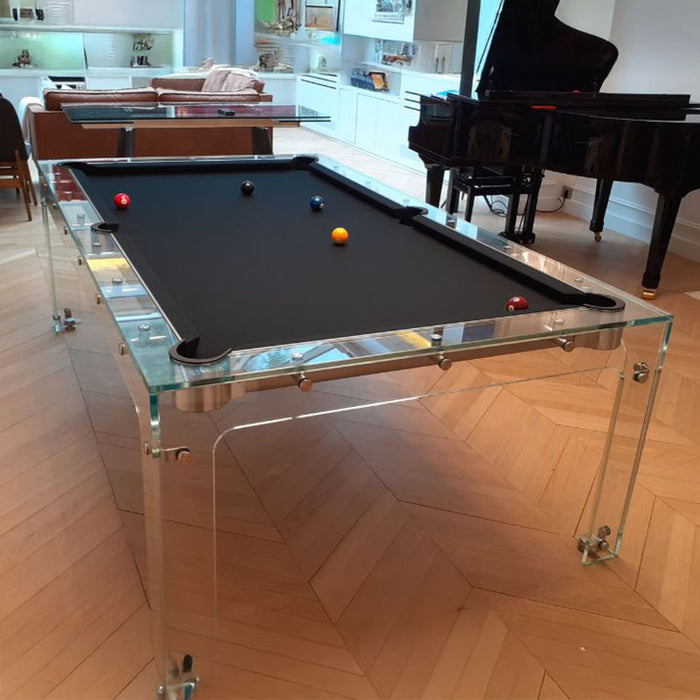 Transparent Billards Toulet Carat Light design pool table with black felt, elegantly styled in a modern home with a grand piano and parquet flooring.
