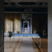 Carat Light transparent pool table with blue felt by Billards Toulet displayed in a regal hallway with antique décor and chandeliers.