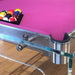 Striking close-up of a pink felt Billards Toulet Carat Light pool table with clear glass frame and vibrant billiard balls.
