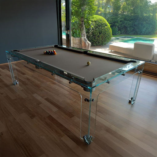 Billards Toulet Carat Light pool table with taupe felt in a serene interior space, positioned beside large windows overlooking a private pool.