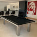 Sleek black billiards table in a stylish open kitchen-diner space with contemporary art and monochrome theme.