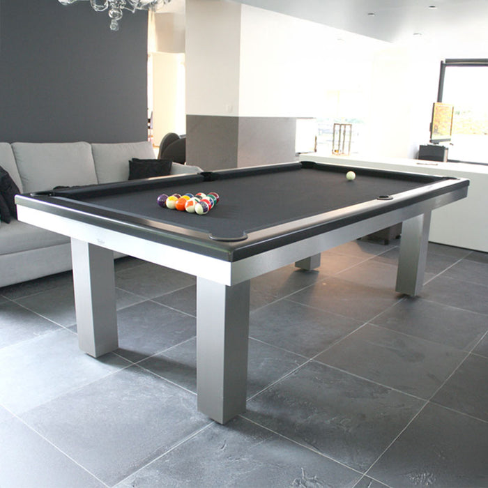 Full Loft Design pool table with dark finish in a bright room featuring grey tile flooring and soft seating.