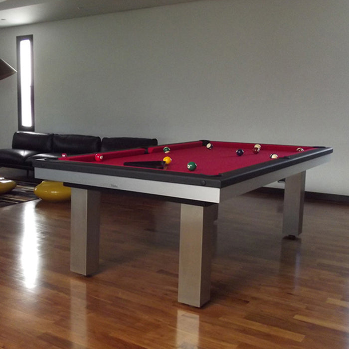 Contemporary red felt pool table in a bold lounge space with wood flooring and designer black seating.