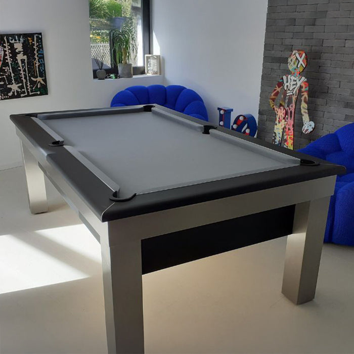 Contemporary space showcasing a grey and black Billards Toulet Lambert Competition Pool Table surrounded by bold blue lounge chairs and street-art styling.