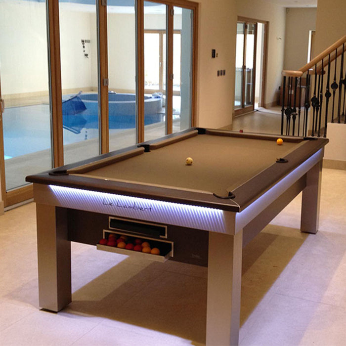 Contemporary indoor leisure space with the Billards Toulet Lambert Competition Pool Table, LED lighting, and poolside views through glass sliding doors.