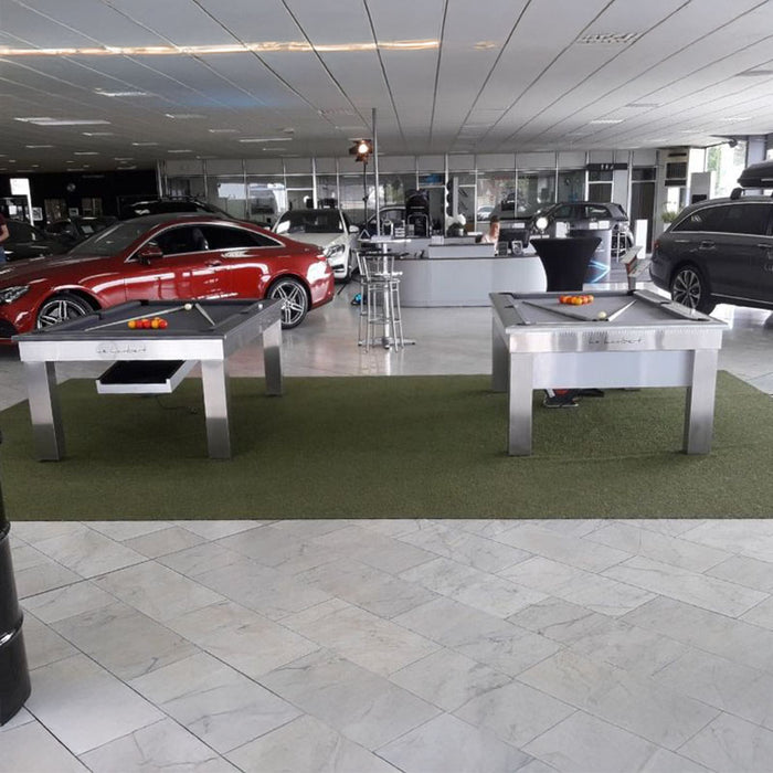 Showroom featuring two brushed steel Billards Toulet Lambert Competition Pool Tables, creating a unique blend of automotive luxury and gaming entertainment.