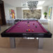 Glossy black frame pool table with striking magenta felt in a vibrant, art-filled contemporary interior.