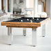 Sleek and modern Billards Toulet Megeve pool table in black felt and chrome legs, placed in a bright open-plan contemporary loft.