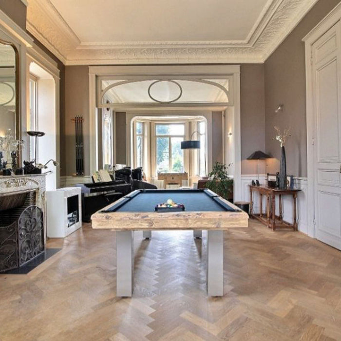 Elegant interior showcasing the Billards Toulet Megeve pool table with dark cloth and natural wood finish in a classic Parisian-style room.