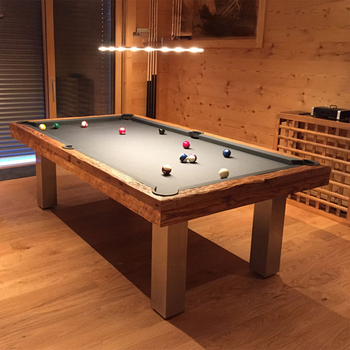 Billards Toulet Megeve modern pool table with grey cloth and brushed metal legs in a timber-clad chalet room with ambient lighting.
