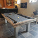 Megeve modern pool table by Billards Toulet in a classic games room, with grey cloth, brushed steel legs, and a vintage slate floor.