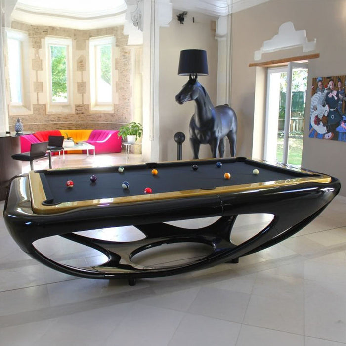 Glossy black Billards Toulet Whitelight pool table with gold trim in a stylish room featuring a black horse lamp, high windows and vibrant furniture.