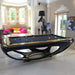 Glossy black Billards Toulet Whitelight pool table with gold trim in a stylish room featuring a black horse lamp, high windows and vibrant furniture.