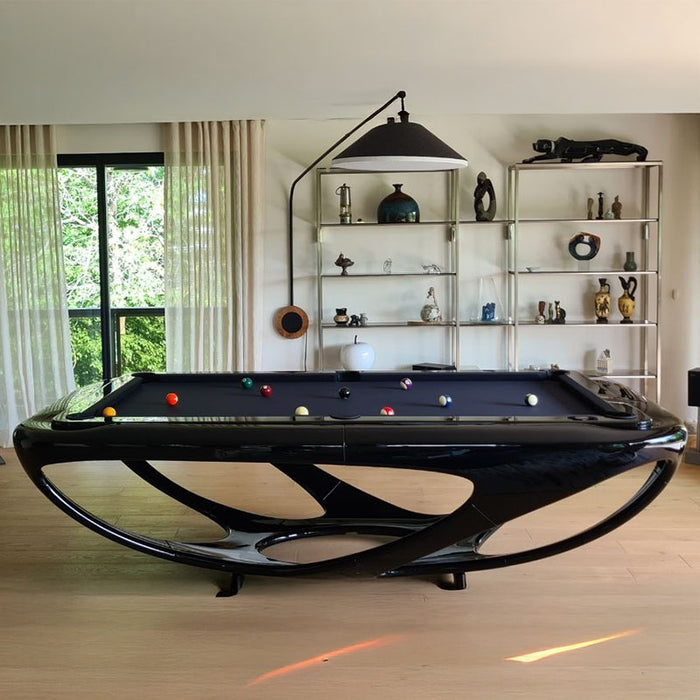Elegant black Billards Toulet Whitelight pool table in a stylish, art-filled room with wooden floors and natural light, perfect for contemporary interiors.