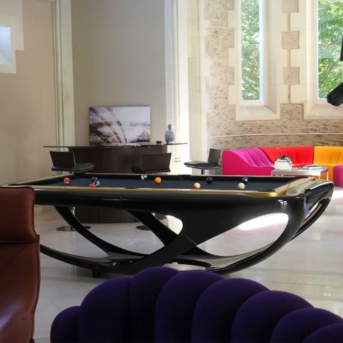 Modern black Billards Toulet Whitelight pool table in a bright, luxury lounge with colourful designer sofas and artistic decor. A bold centrepiece for high-end interiors.