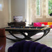 Modern black Billards Toulet Whitelight pool table in a bright, luxury lounge with colourful designer sofas and artistic decor. A bold centrepiece for high-end interiors.
