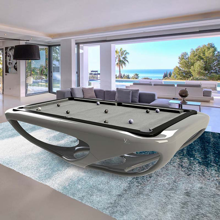 Elegant white Billards Toulet Whitelight pool table with blue playing surface in an artistic space with curved architecture and creative wall mural.