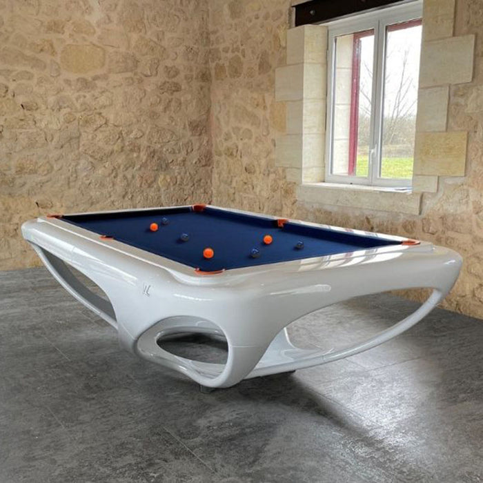 Glossy white Billards Toulet Whitelight design pool table set in a rustic stone-walled room, blending modern elegance with vintage charm.