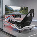 BPS Blade Racing Simulator in white Carrera livery with green accent lighting, full rig side profile against a dark studio background
