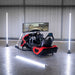 BPS Phoenix Commercial Racing Simulator front-right angle in hangar showing full red and black F1-style chassis with screen off and Phoenix side bracket