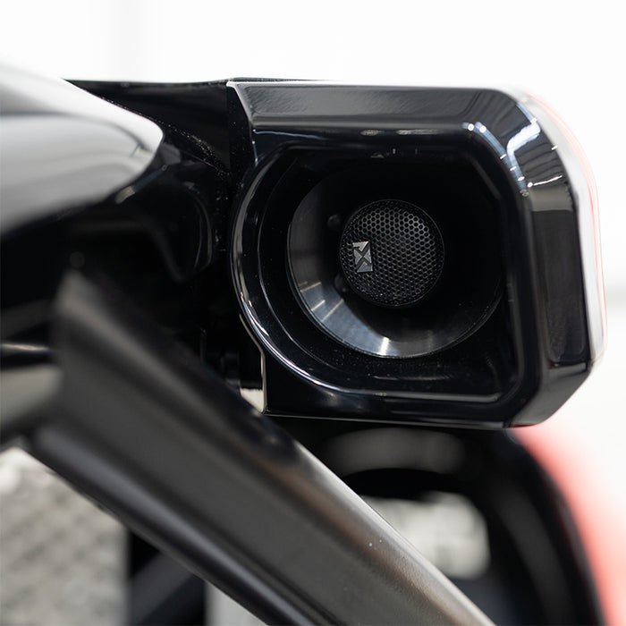 BPS Phoenix Commercial Racing Simulator built-in speaker unit mounted on the chassis roll hoop showing horn-style audio driver in gloss black housing