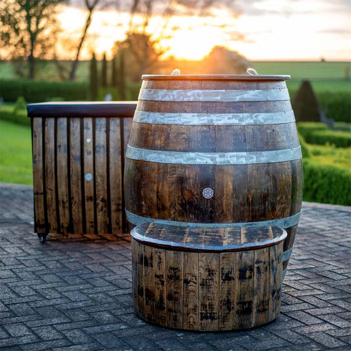 The Brass Monkey Cold Plunge Barrel setup at sunset, blending timeless design with a serene outdoor setting for rejuvenating cold therapy.