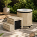Celsium Aiste Ice Bath Classic in a natural wood finish with integrated steps on a contemporary garden patio, premium outdoor cold plunge for recovery, wellness and ice bath therapy.