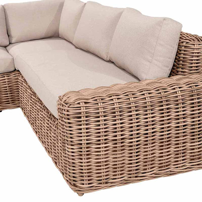 Detail view of the left side of the Como Natural Antique Outdoor Corner Seating Set, showcasing the durable rattan texture and soft cushions that enhance your outdoor seating experience.