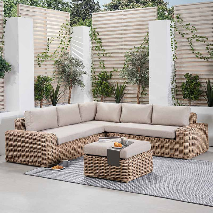 Como Natural Antique Outdoor Corner Seating Set displayed in a modern garden, featuring a natural rattan weave and soft beige cushions, perfect for stylish and comfortable outdoor living