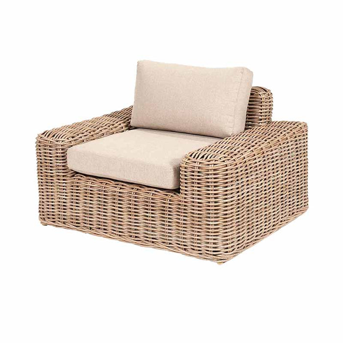 Detailed view of the Como Natural Antique Outdoor Armchair, showcasing the robust design with synthetic rattan in a natural antique finish. The armchair includes a soft beige cushion, providing a comfortable and stylish seating option as part of the outdoor set.