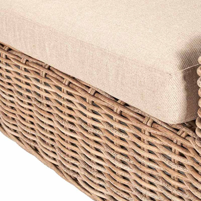 A close-up angle of the cushion and rattan weave detail from the Como Natural Antique Outdoor Seating Set. The natural tones and soft beige fabric create a cohesive and elegant look for any outdoor space.